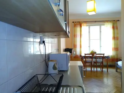 a kitchen with a stove top oven next to a living room at Best Location in Prague - Old Town in Prague