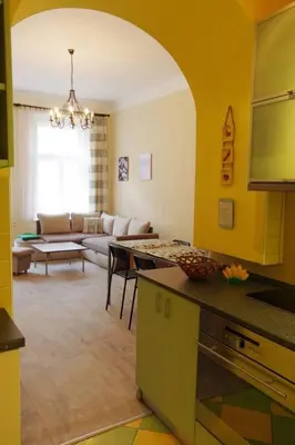 a kitchen and living room with a couch and a table at Nice big apartment in the city center in Prague