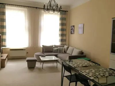 a living room with a couch and a table at Nice big apartment in the city center in Prague