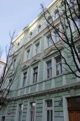 a green and white building with many windows at Nice big apartment in the city center in Prague