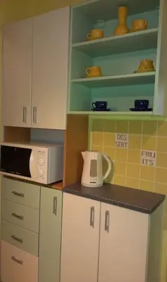 a kitchen with white cabinets and a microwave at Nice big apartment in the city center in Prague