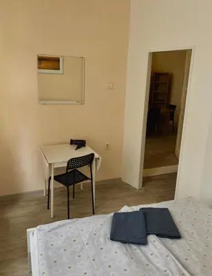 a bedroom with a bed and a desk and a table at Nice big apartment in the city center in Prague