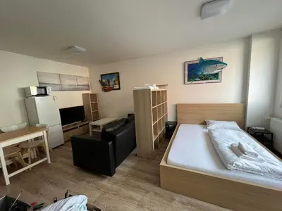a small room with a bed and a kitchen at Beroun apartments in Beroun