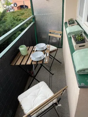 a balcony with a table and chairs on a balcony at Beroun apartments in Beroun
