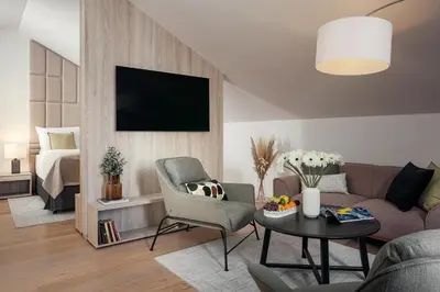 a living room with a couch and a table and a bed at U Pujcovny Apartment Old Town Prague in Prague