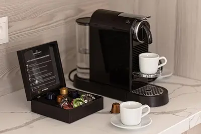a coffee maker and coffee cups on a counter at U Pujcovny Apartment Old Town Prague in Prague