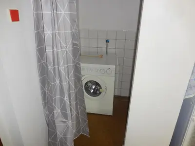 a bathroom with a washing machine and a washer at Apartmán u zámku in Smečno