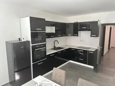 a kitchen with black cabinets and a black refrigerator at Byt 71m2 klid pohoda a příroda in Prague