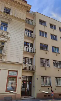 a man is standing outside of a building at Cozy & New Studio Apartment PEACE SQ. in Prague