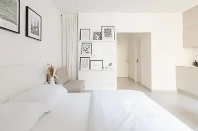 a white room with a bed and a couch at Cozy & New Studio Apartment PEACE SQ. in Prague
