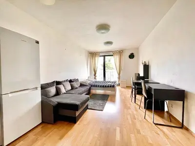 a living room with a couch and a table at Garden Park Studio in Prague
