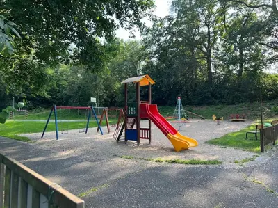a playground with a slide in a park at Apartmán byt 75m2 klid příroda pro rodinu in Prague