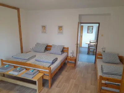 a bedroom with two beds and a hallway at Hrnčírna in Kněževes