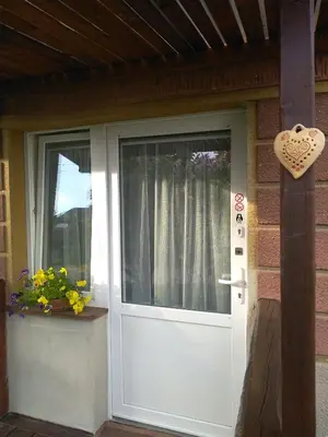 a white door to a house with a heart on it at Hrnčírna in Kněževes