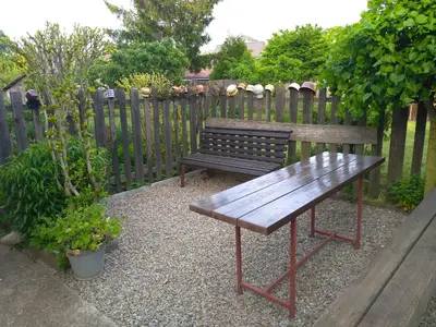 a wooden bench sitting next to a wooden fence at Hrnčírna in Kněževes