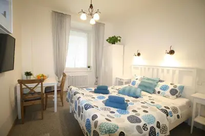 a bedroom with a large bed with blue and white pillows at Finnem Home Rentals in Prague