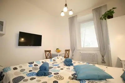 a bedroom with a bed with two stuffed animals on it at Finnem Home Rentals in Prague