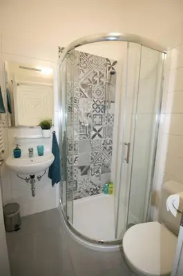 a bathroom with a shower and a toilet and a sink at Finnem Home Rentals in Prague