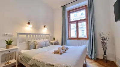 a bedroom with a bed with two teddy bears on it at Finnem Rentals Florenc in Prague