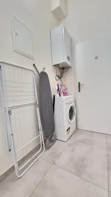 a laundry room with a washer and a washing machine at Finnem Rentals Florenc in Prague