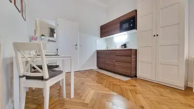 a kitchen with a white table and a white chair at Finnem Rentals Florenc in Prague