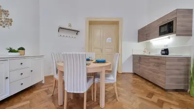 a kitchen with a table and chairs in a room at Finnem Rentals Tyršova in Prague