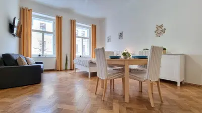 a kitchen and dining room with a table and chairs at Finnem Rentals Tyršova in Prague