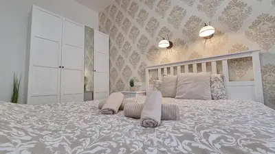 a bedroom with a large bed with two pillows at Finnem Rentals Tyršova in Prague