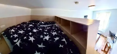 a bedroom with a bed with stars on it at Karlin Cozy Studio in Prague