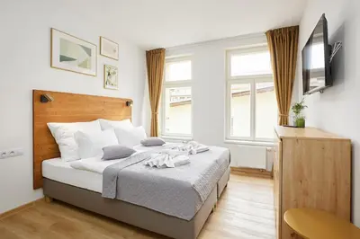 a bedroom with a bed and a television in it at Residence 44 in Prague