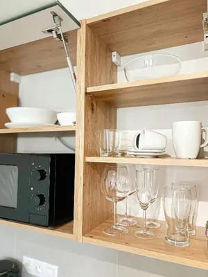 a kitchen with wine glasses and a microwave at Residence 44 in Prague