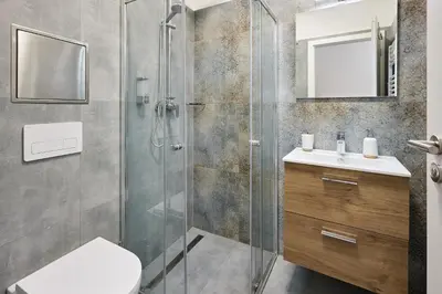 a bathroom with a shower and a toilet and a sink at Residence 44 in Prague