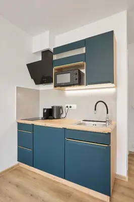 a kitchen with blue cabinets and a sink at Residence 44 in Prague
