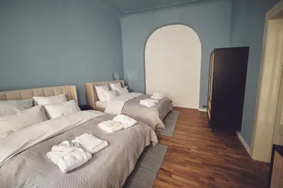 a room with two beds with towels on them at Domus Balthasar Boutique Hotel in Prague