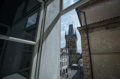 a view from a window of a building with a clock tower at Domus Balthasar Boutique Hotel in Prague