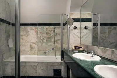 a bathroom with a shower and a sink and a tub at Prague Old Street Apartments in Prague