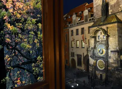 a view of a clock tower from a window at Prague Old Street Apartments in Prague