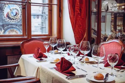 a table in a restaurant with wine glasses on it at Prague Old Street Apartments in Prague