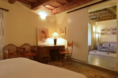 a bedroom with a bed and a desk with a lamp at Prague Old Street Apartments in Prague