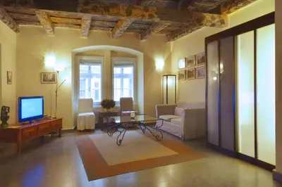 a living room with a tv and a couch and a table at Prague Old Street Apartments in Prague