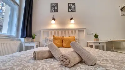 a bed with two pillows on it in a bedroom at Finnem Rentals Pod Znonařkou in Prague