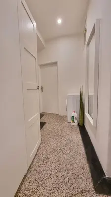an empty room with a door and a carpeted floor at Finnem Rentals Pod Znonařkou in Prague