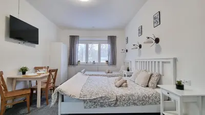 a bedroom with a bed with a teddy bear on it at Finnem Rentals Jičínská in Prague