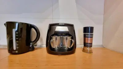 affeepot and a coffee maker sitting on a table at Finnem Rentals Zíkova in Prague