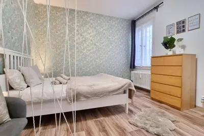 a bedroom with a swinging bed in a room at Finnem Rentals Sokolovská in Prague