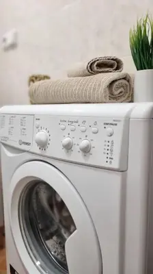 a white washing machine with a towel on top of it at Finnem Rentals Sokolovská in Prague