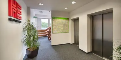 an office hallway with plants and a map on the wall at Hotel Energie in Prague