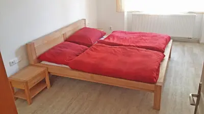 a bed with red pillows on it in a room at New apartment in a historical building in Prague