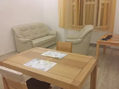 a living room with a table and two chairs at New apartment in a historical building in Prague