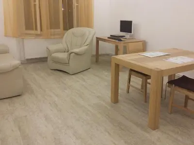 a waiting room with a chair and a table and a chair at New apartment in a historical building in Prague